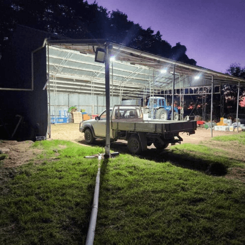 Farm shed lit up at night